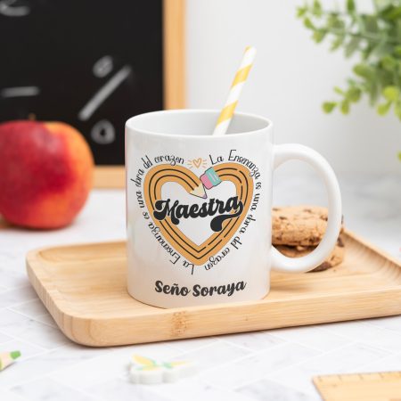Taza personalizada con el texto ‘Maestra' y ‘La enseñanza es una obra del corazón', nombre de la profesora, curso y nombres de los niños en el reverso